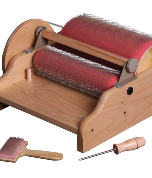 Ashford drum carder shown with its wooden-handled awl and doffer