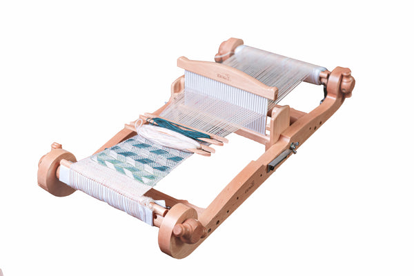 Wooden kromski weaving loom with fabric on a white background